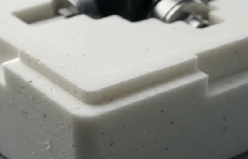 Close-up of the dense, fine-cell edge of a PU foam packaging cushion